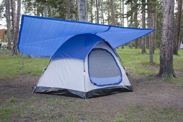 tent with tarp over it in rain