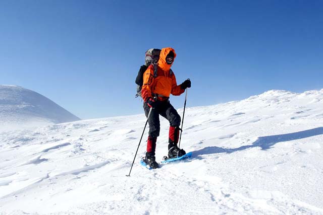 winter hiker with snowshoes