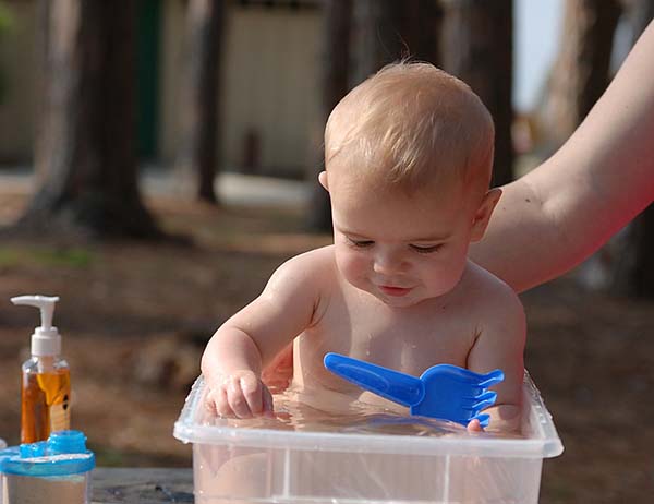 using a bucket to give a bath a bath when camping