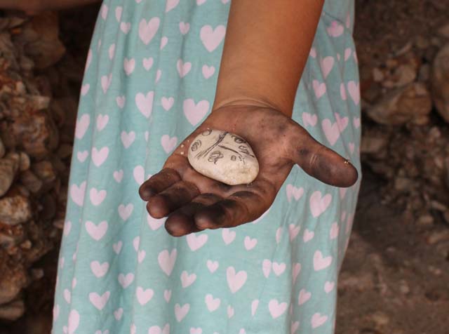 camping activity for kids drawing with charcoal from fire