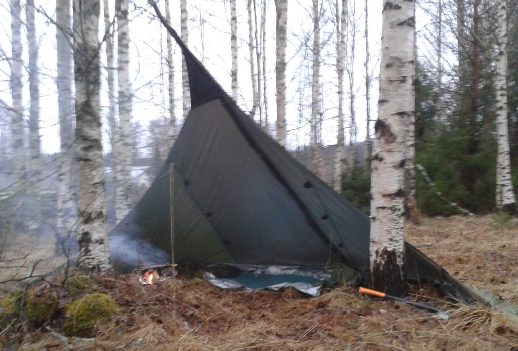 Make your fire at the mouth of the loue tent to keep the rain out of it.