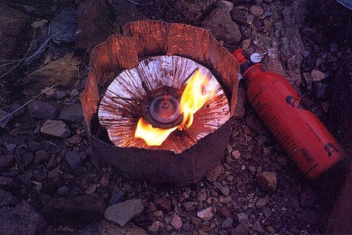 The MSR Whisperlite being used with a wind screen